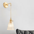 Avtoit | A wall light with a bulb and conical shade made of clear, textured glass, industrial bedroom wall light fixture
